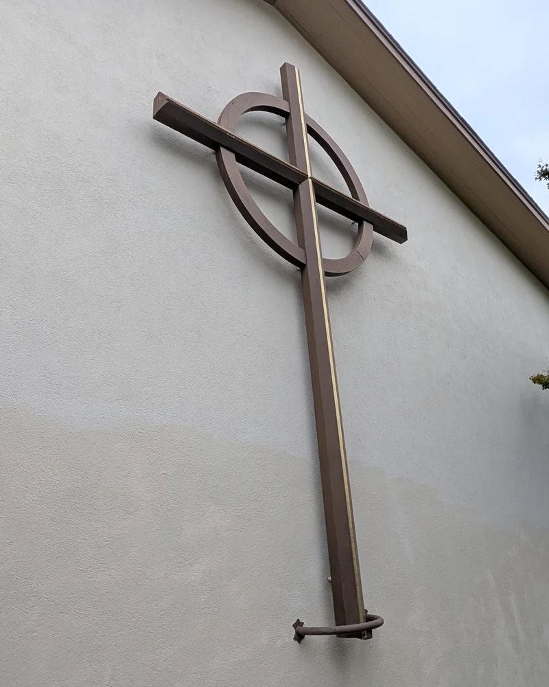 A Celtic cross mounted on one of the present-day buildings on the PCLG campus