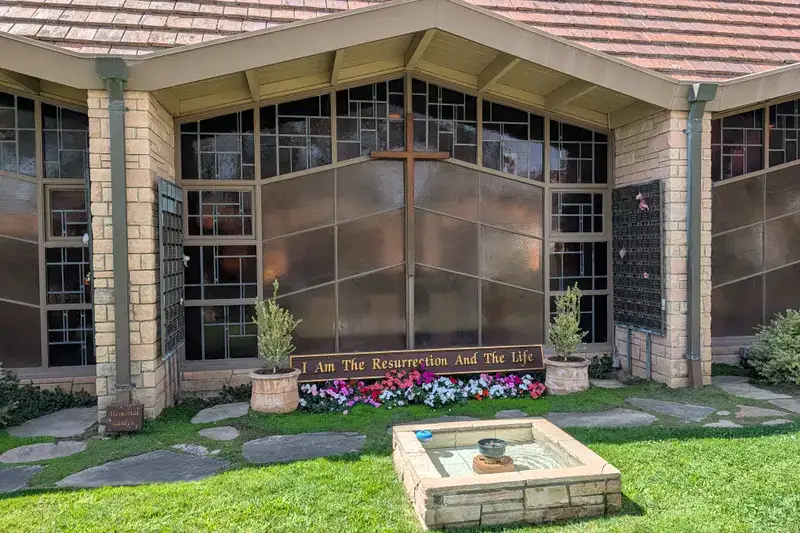 The Memorial Garden beside the Sanctuary, with the window cross, the Resurrection plaque, and the stone fountain