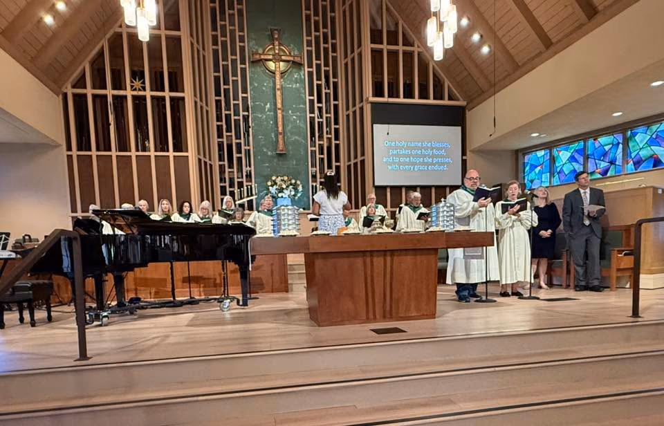 Choir members singing across the front of the PCLG Sanctuary.
