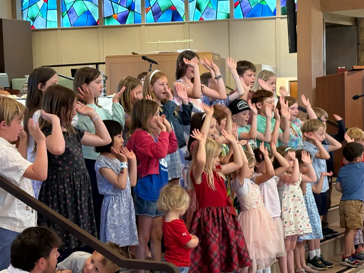 Children singing together at the front of the PCLG Sanctuary.
