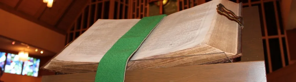 The church's historic Bible open on the sanctuary lectern.