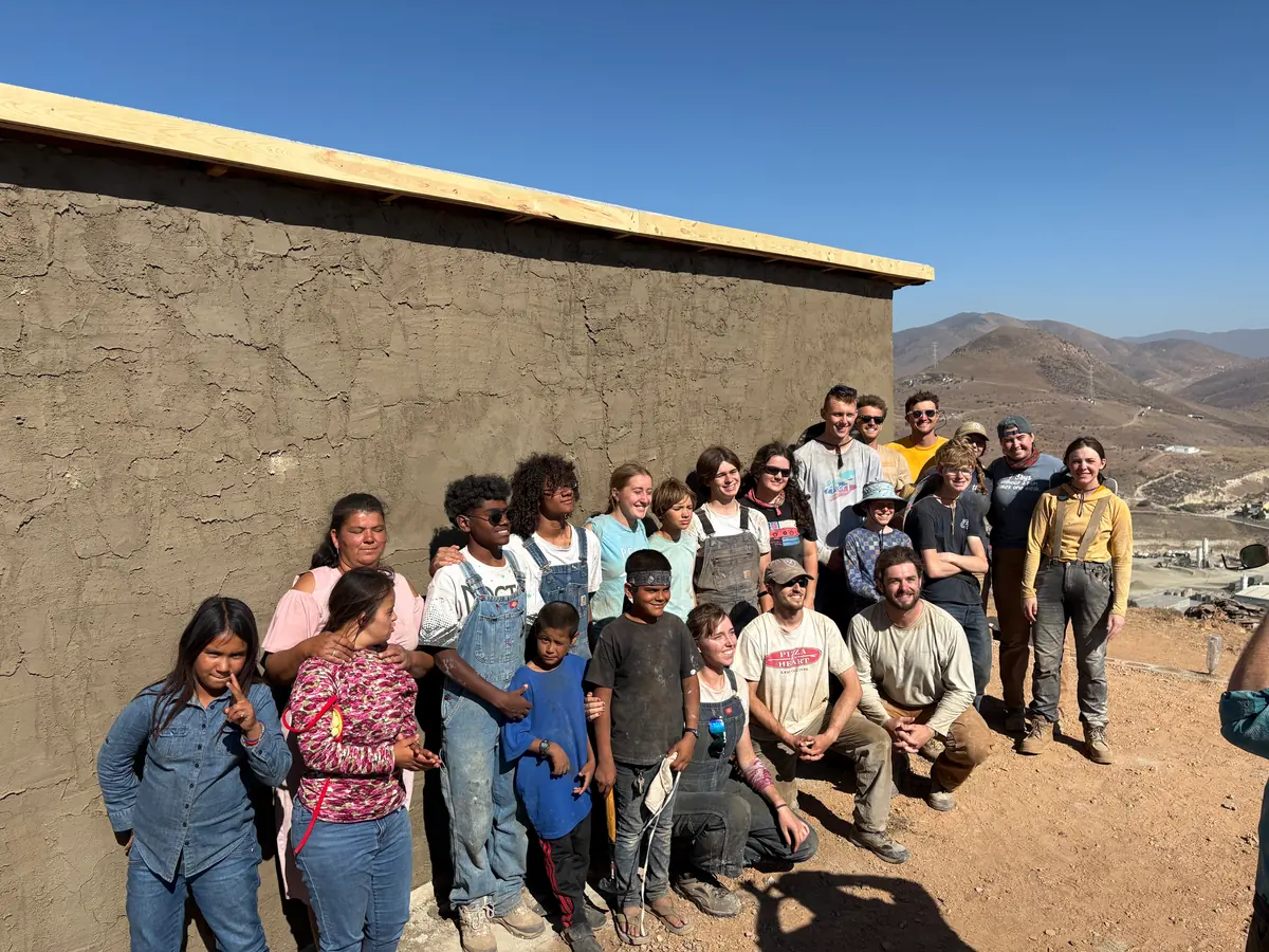 A PCLG build team and local family together outside a completed home in Mexico.