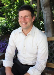 The Rev. Dr. David G. Watermulder seated on a garden bench.