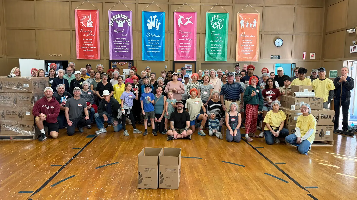 The PCLG Rise Against Hunger volunteer group together in Fellowship Hall.