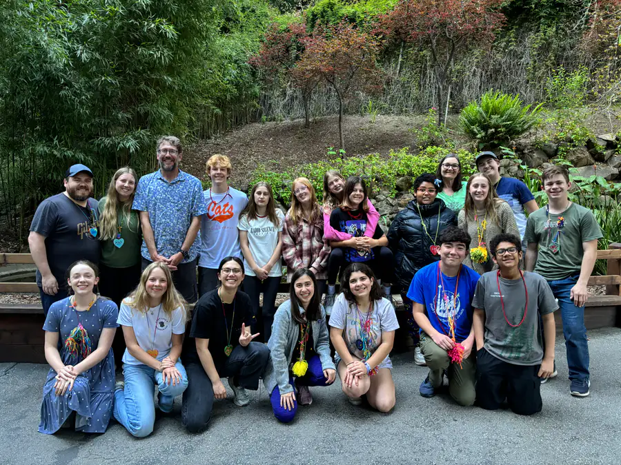 PCLG youth and adult leaders gathered outdoors during a Love of God retreat.
